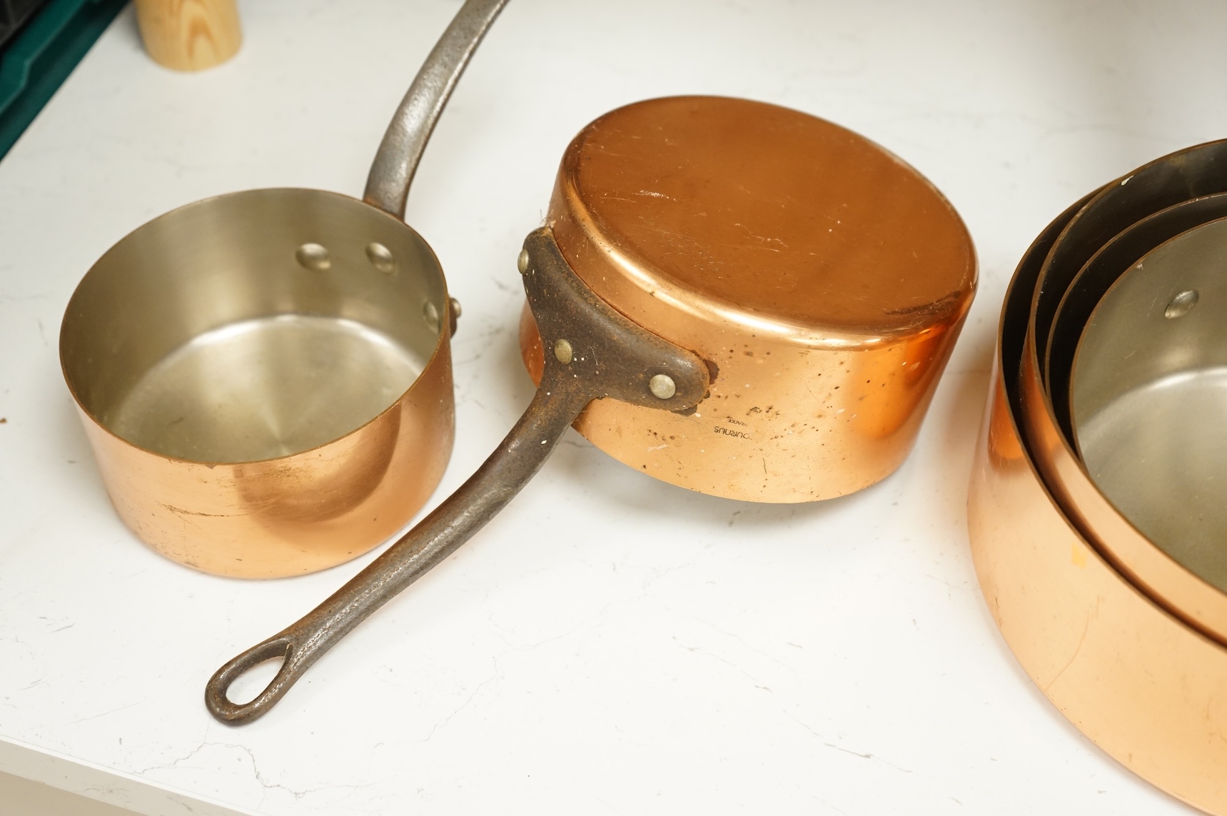 A graduated set of six French Tournus copper cooking pans, largest 44cm wide